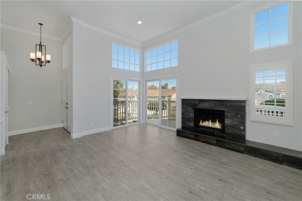 a view of an empty room with a fireplace and a window