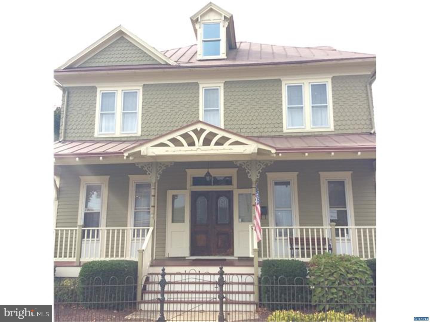 a view of a brick house with large windows