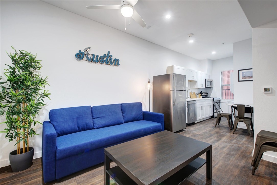 a view of kitchen with furniture and stainless steel appliances