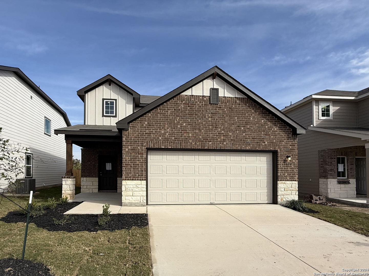 a front view of a house with garage