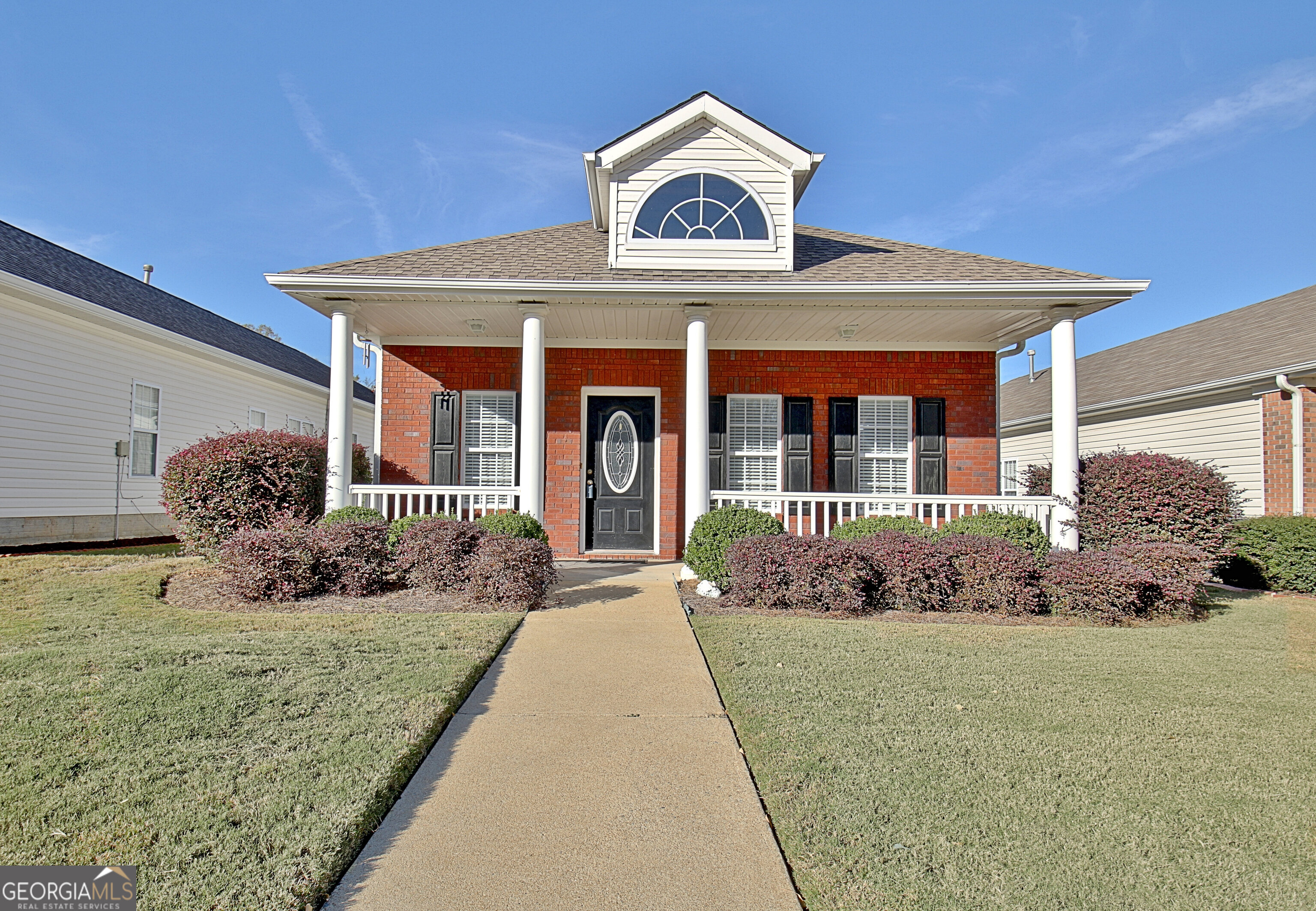 a front view of a house with garden