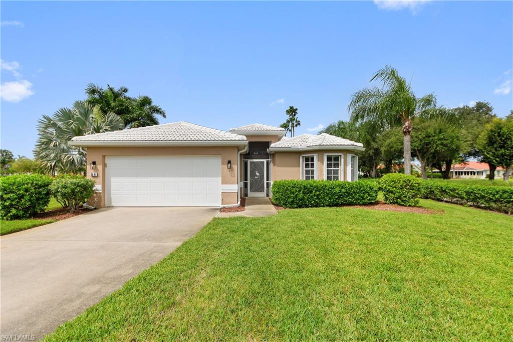 a front view of a house with a yard and garage