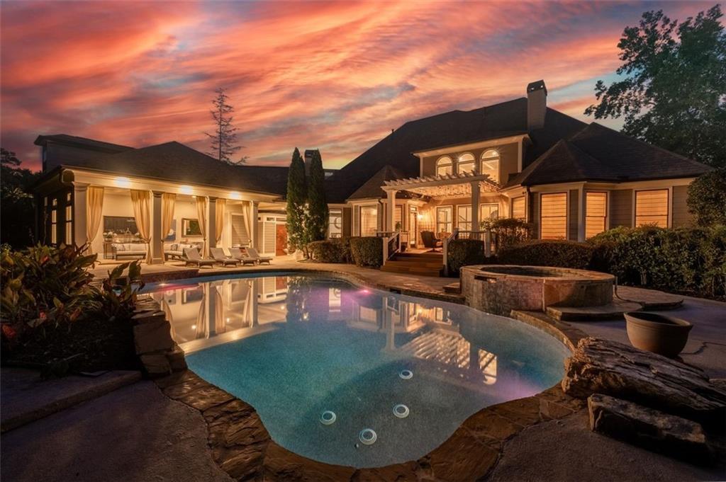 a view of a house with swimming pool and sitting area