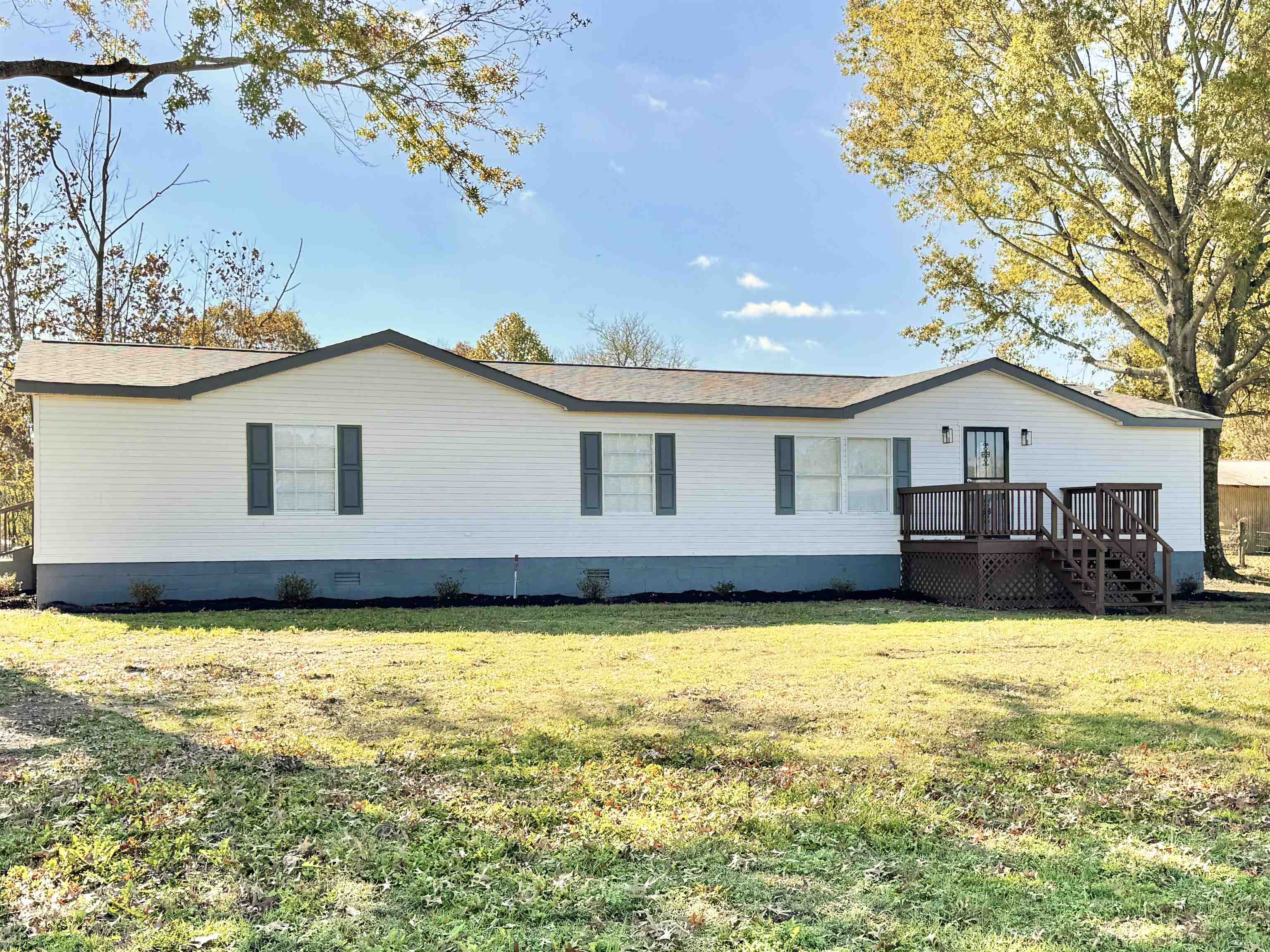 Back of house with a yard and a wooden deck