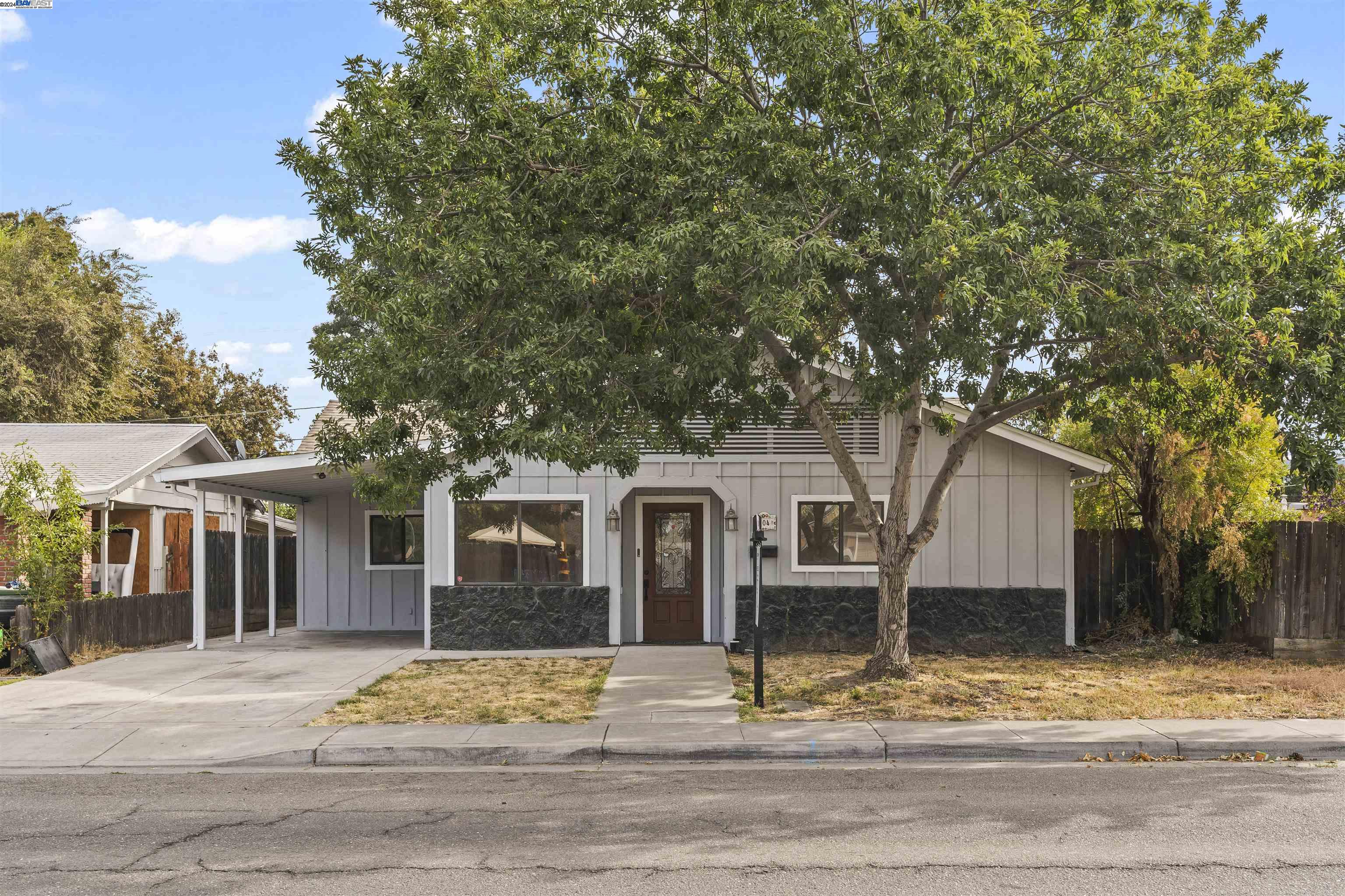 front view of a house with a tree