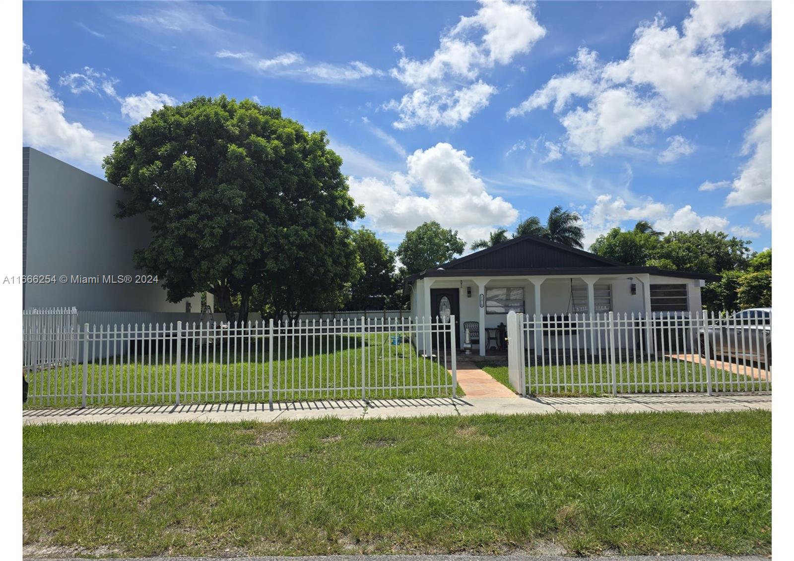 a view of a house with a backyard and a garden