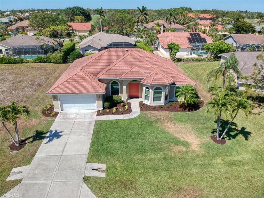 an aerial view of a house with garden space and street view