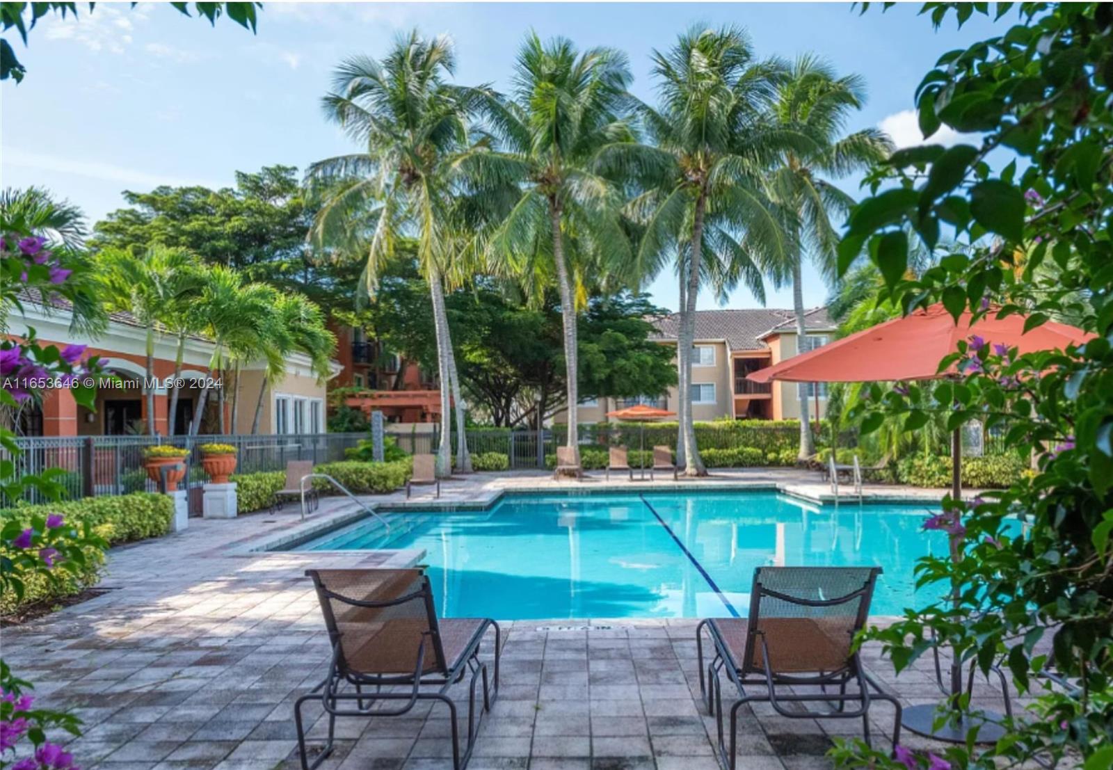 a view of a house with swimming pool and sitting area