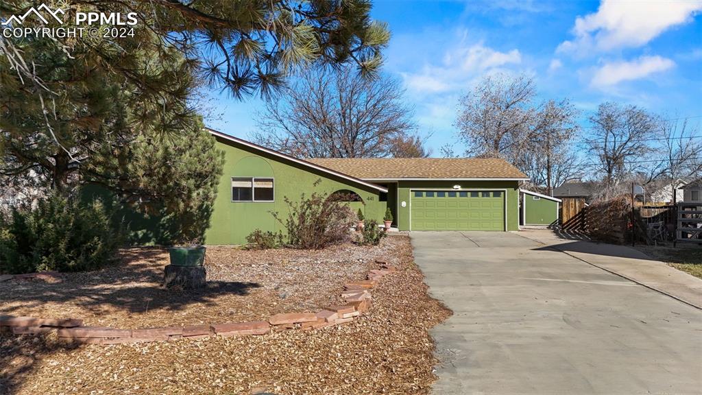 a view of a house with a yard and garage