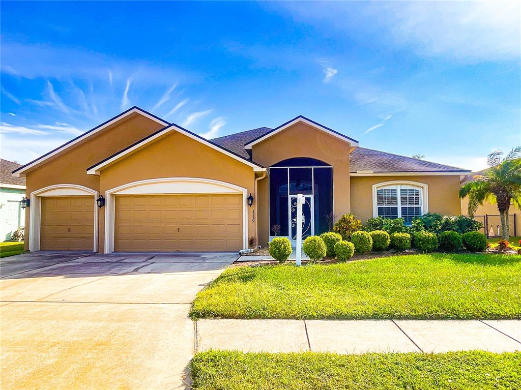 a front view of a house with a yard and garage