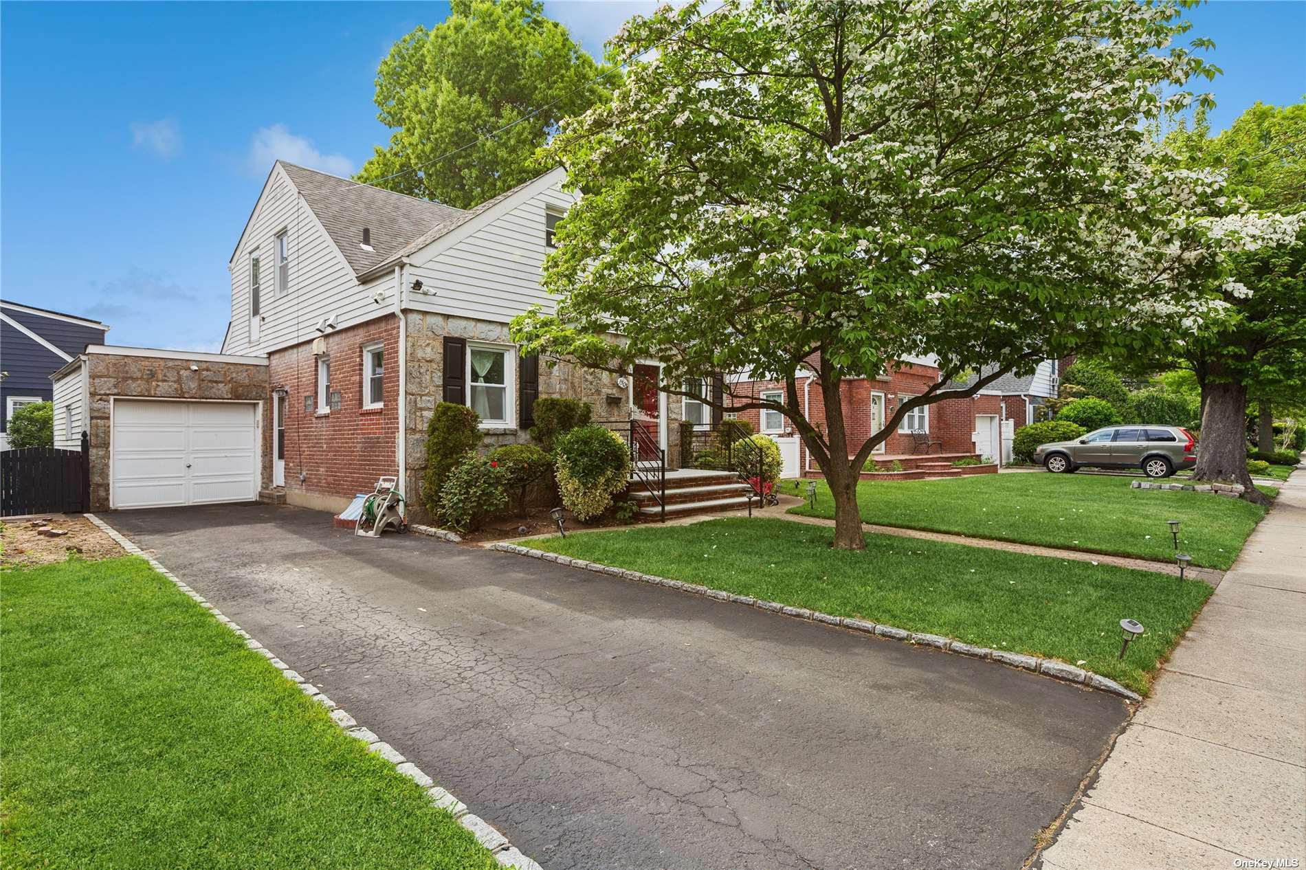 a front view of house with yard and green space