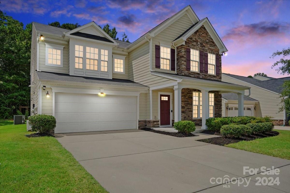 a front view of a house with a yard and garage