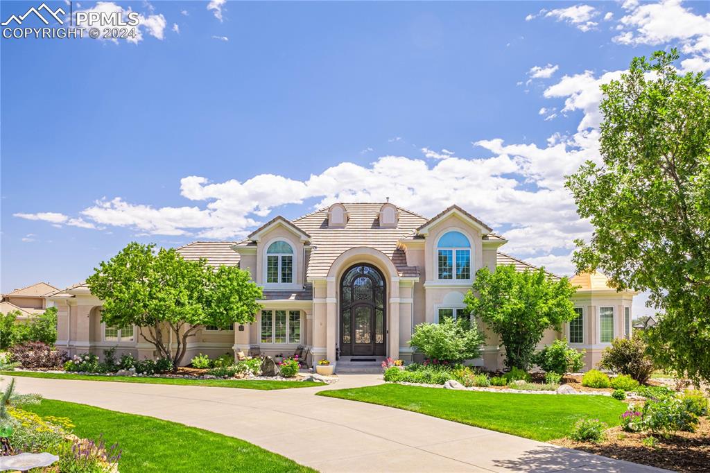 a front view of a house with garden