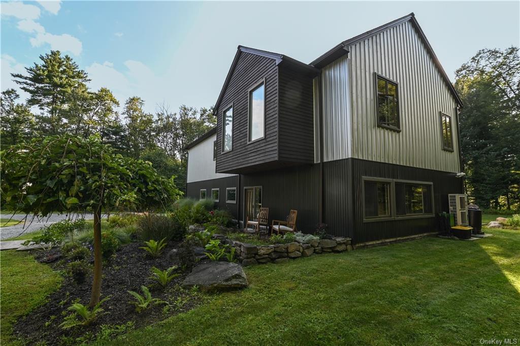 a front view of house with a garden