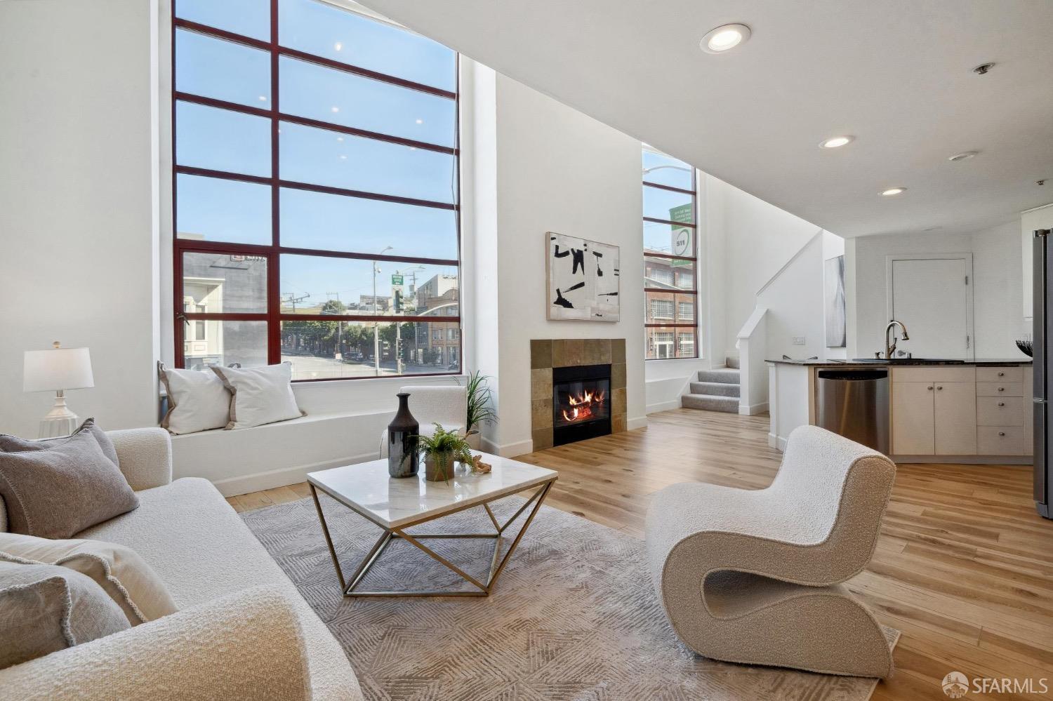 a living room with furniture a rug and a fireplace