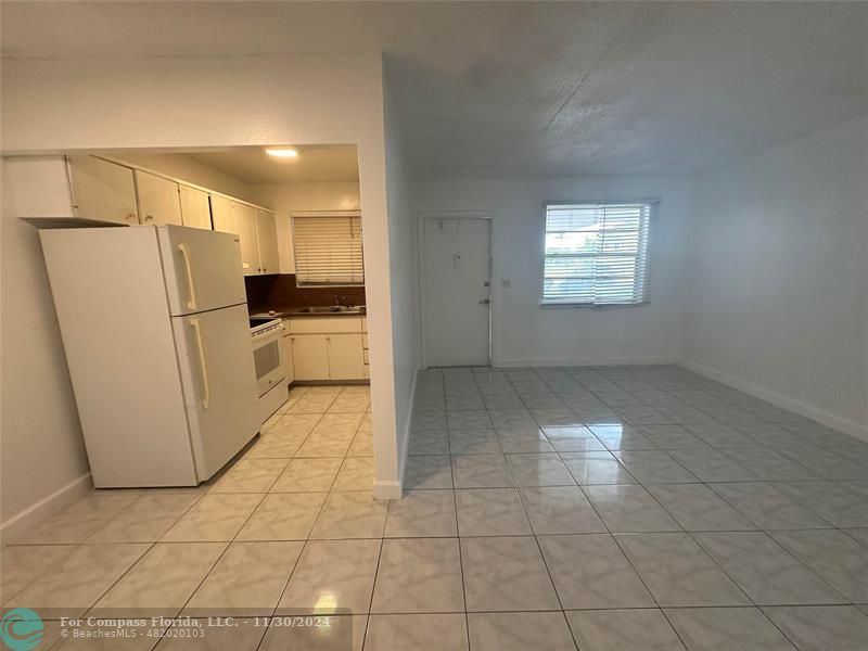 a kitchen with a refrigerator a stove top oven and a counter top space