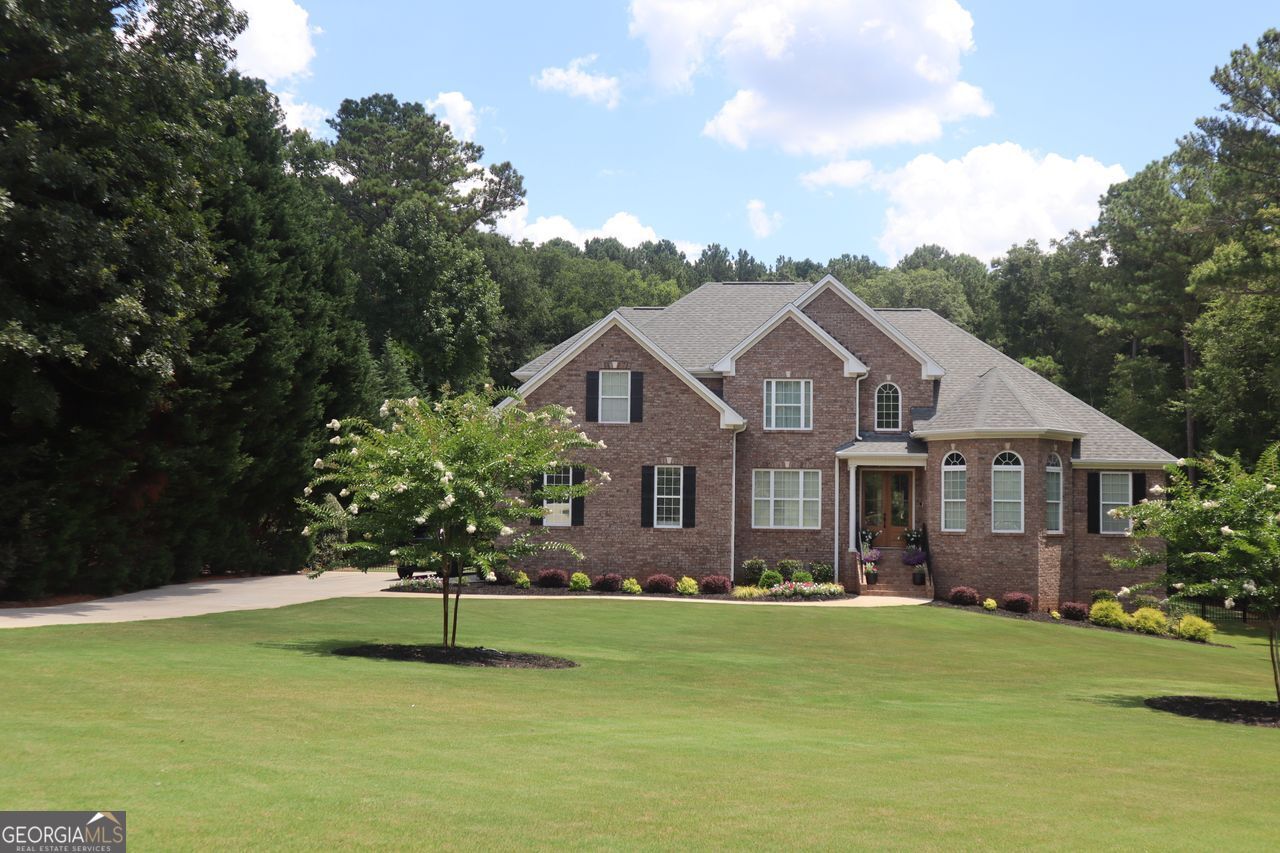 a front view of a house with a garden