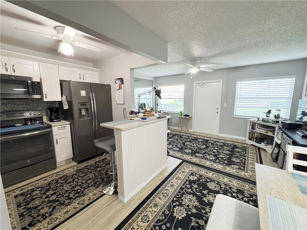 a kitchen with stainless steel appliances a refrigerator sink and stove