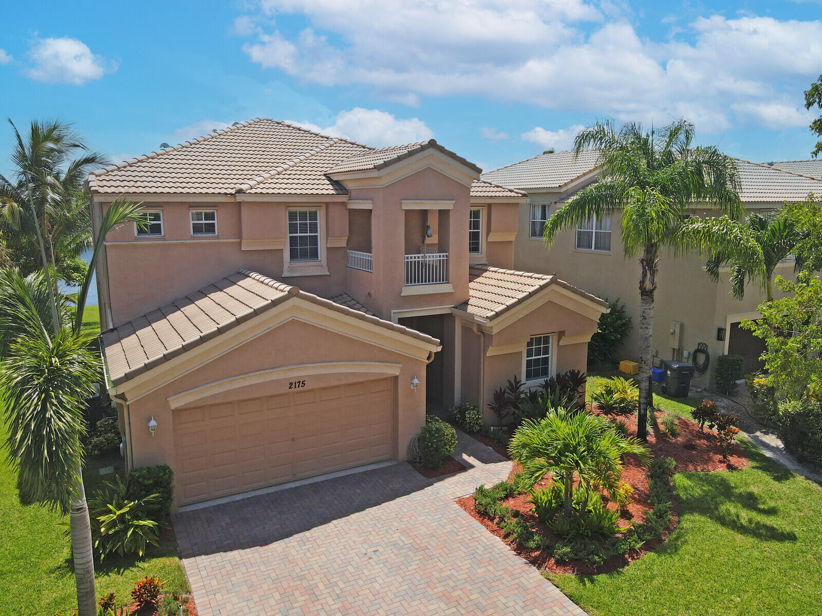 a aerial view of a house with a yard and potted plants