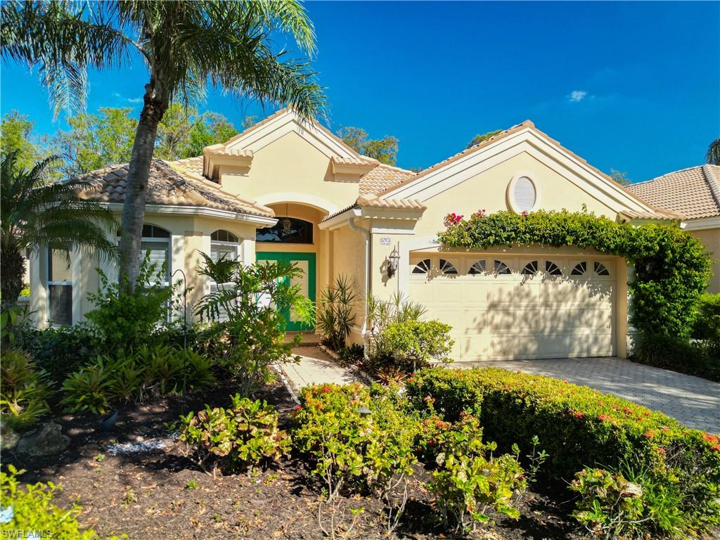 a view of a house with a big yard and potted plants