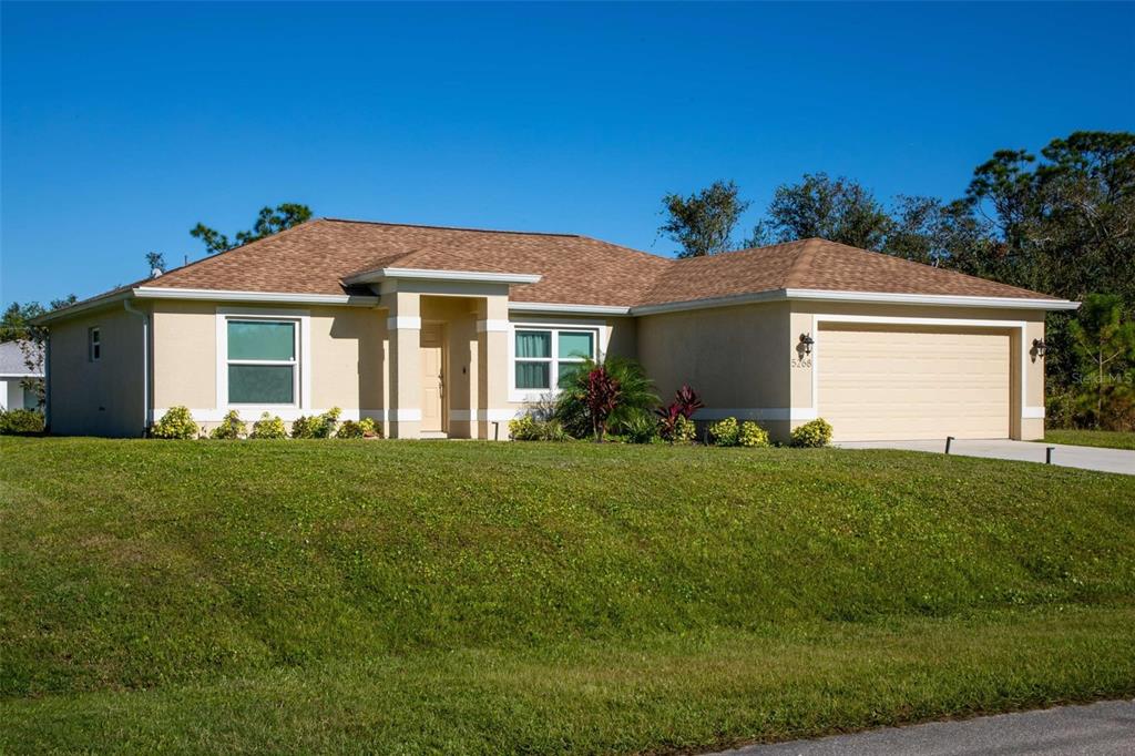 a front view of a house with a garden