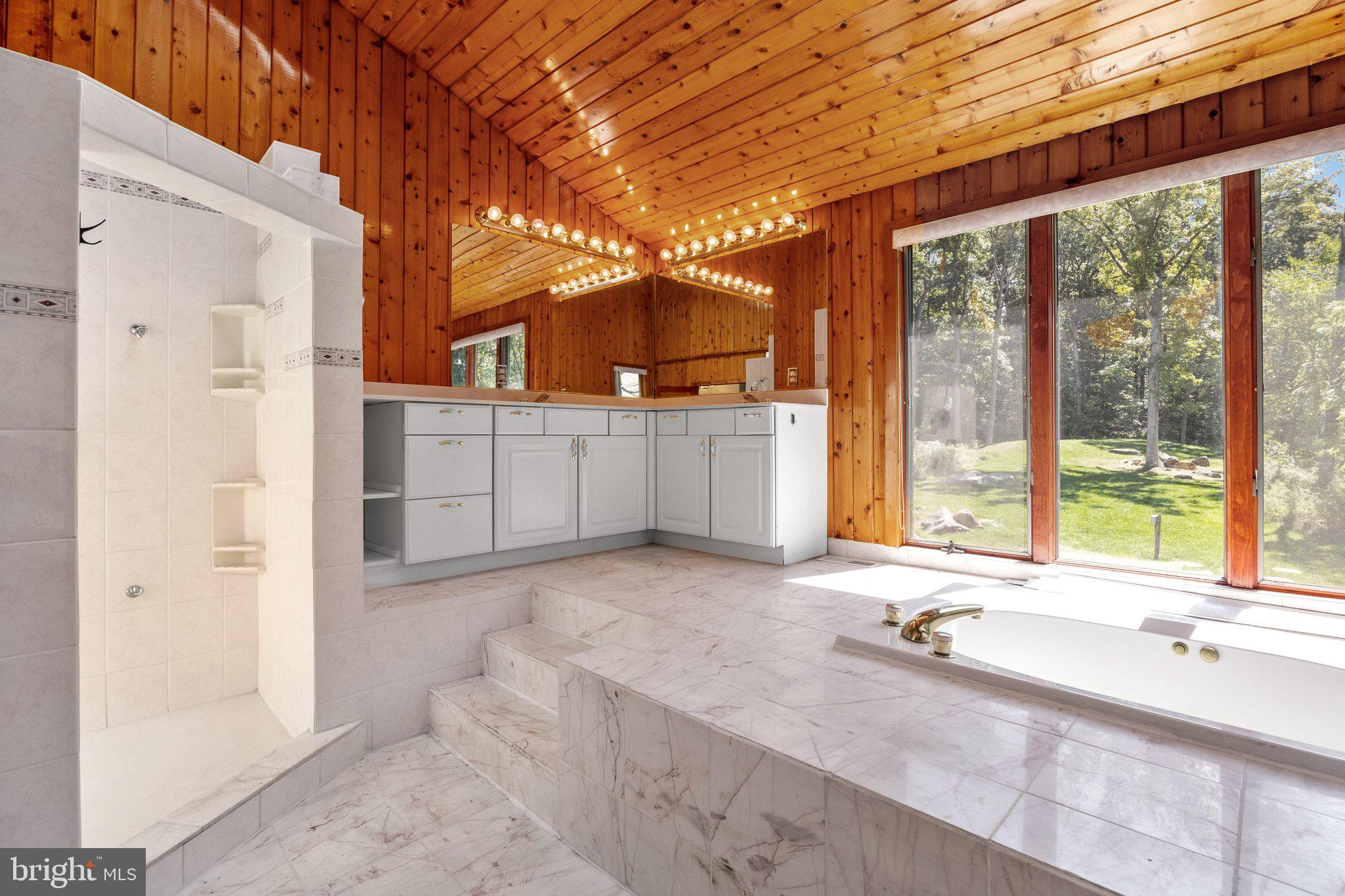 a view of a bathroom with a tub and sink