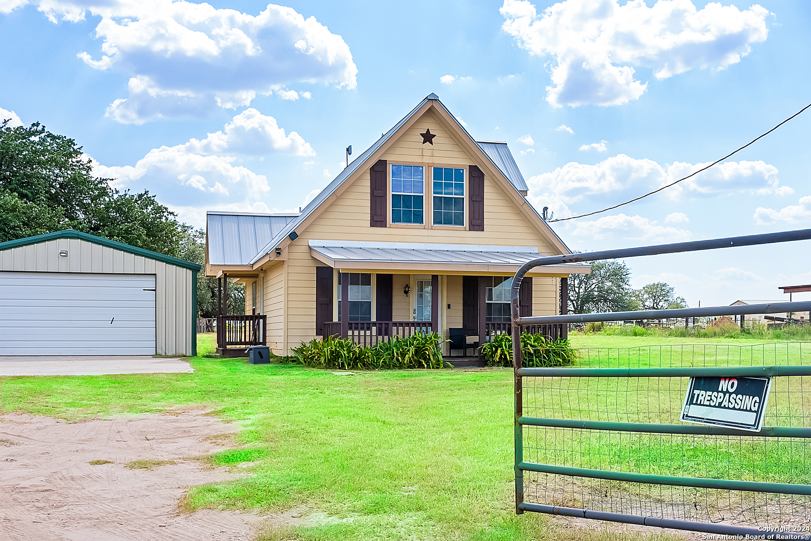 a front view of a house with a yard and green space