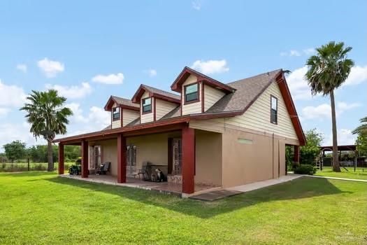 a view of a house with backyard porch and sitting area