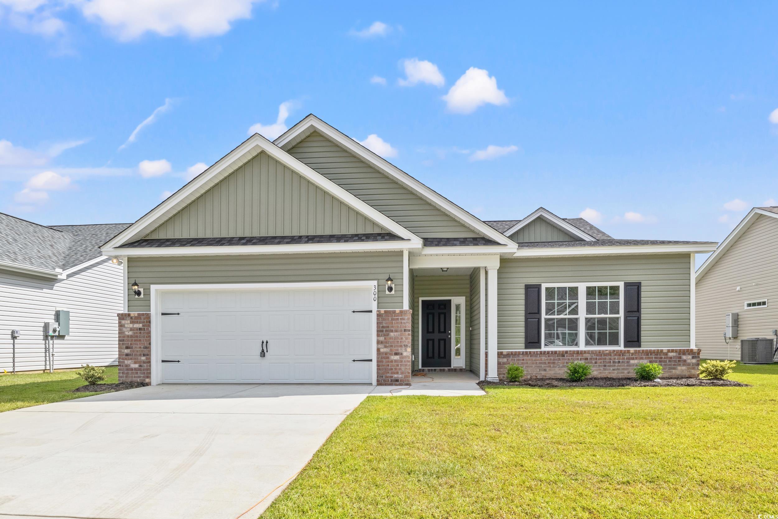 Craftsman-style house with a garage, a front yard,