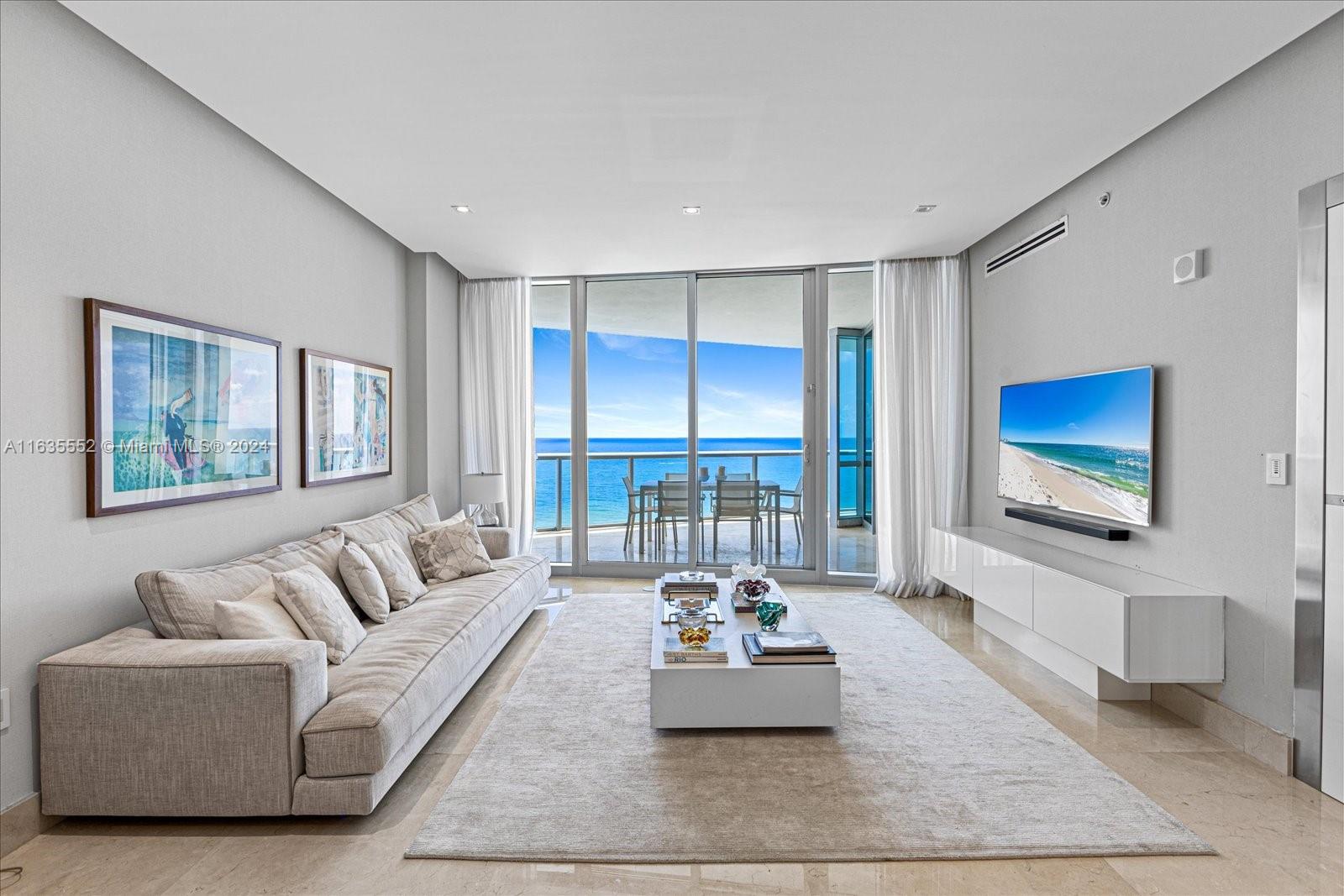 a living room with furniture large window and a flat screen tv