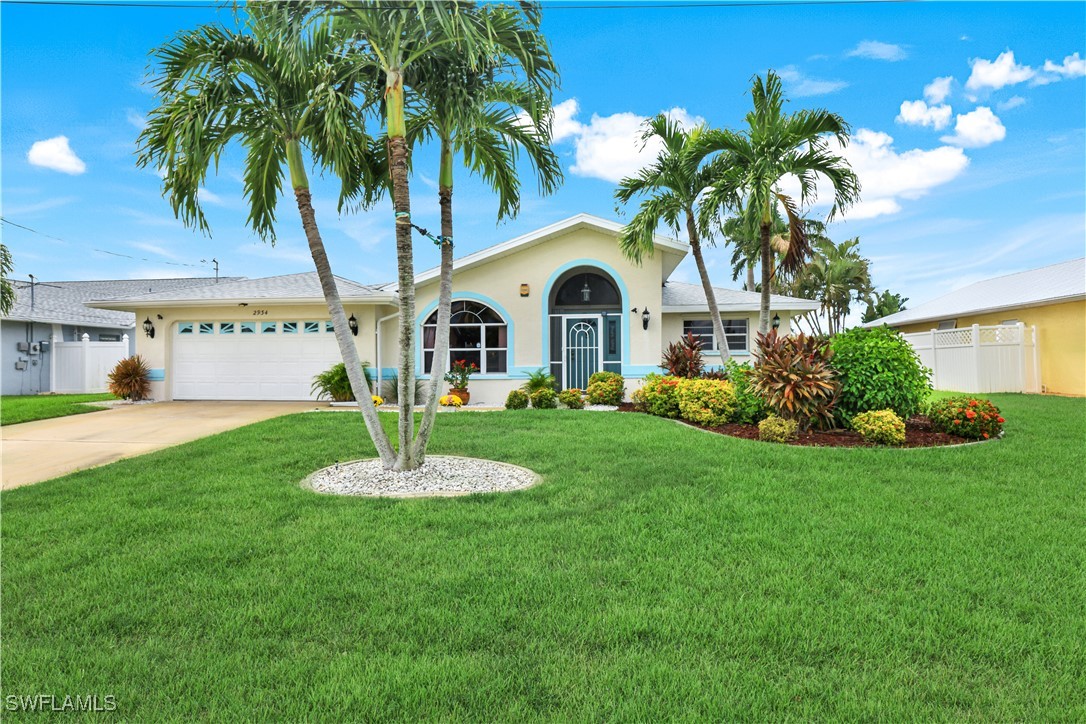 a front view of a house with a yard and fountain