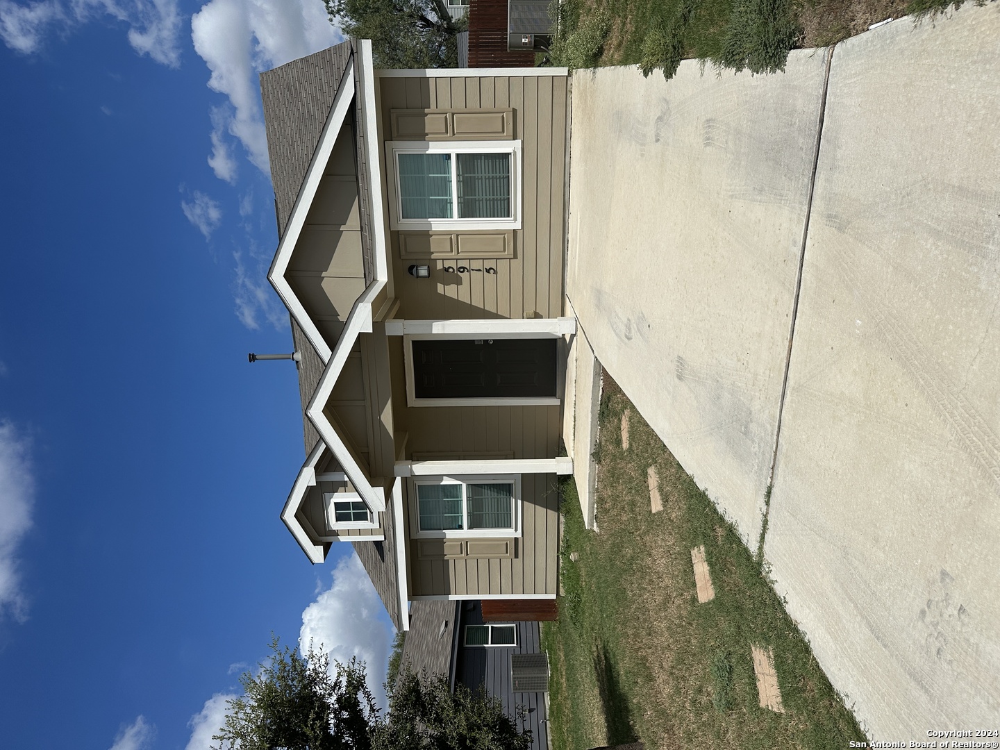 a front view of a house with a yard