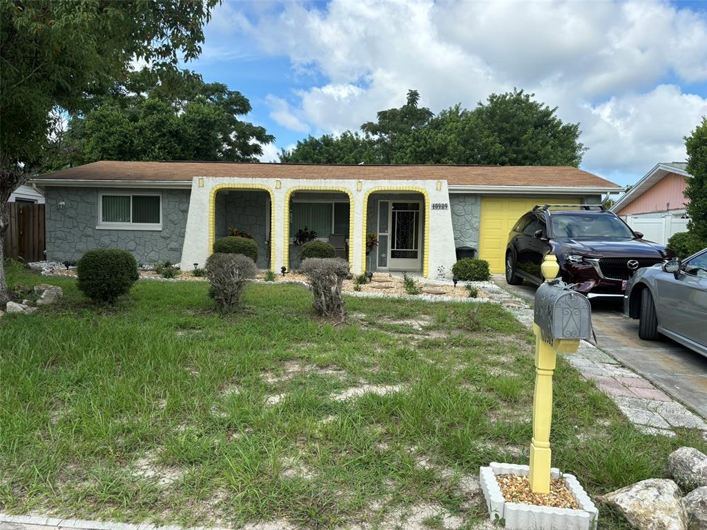 a front view of house with yard and green space