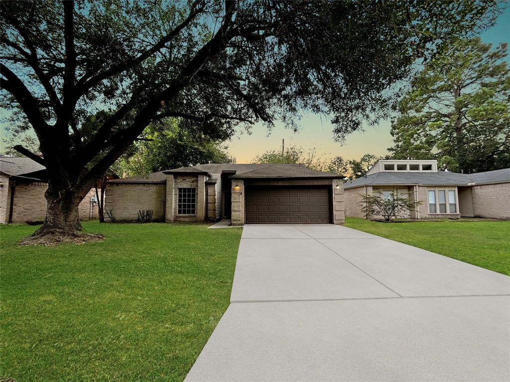 a front view of a house with a garden and yard