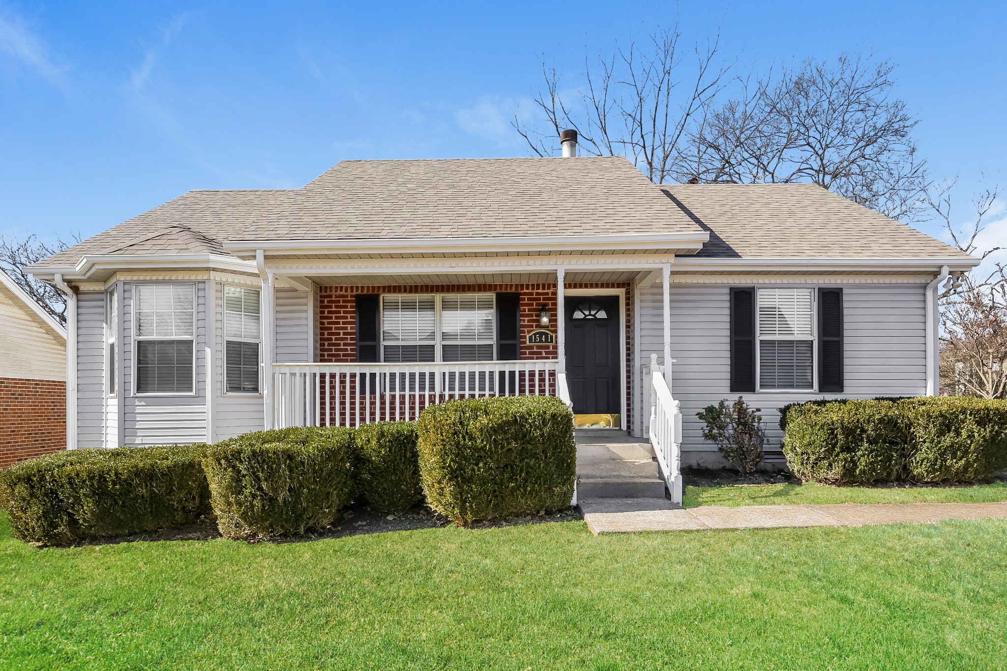 a view of a house with a yard and plants