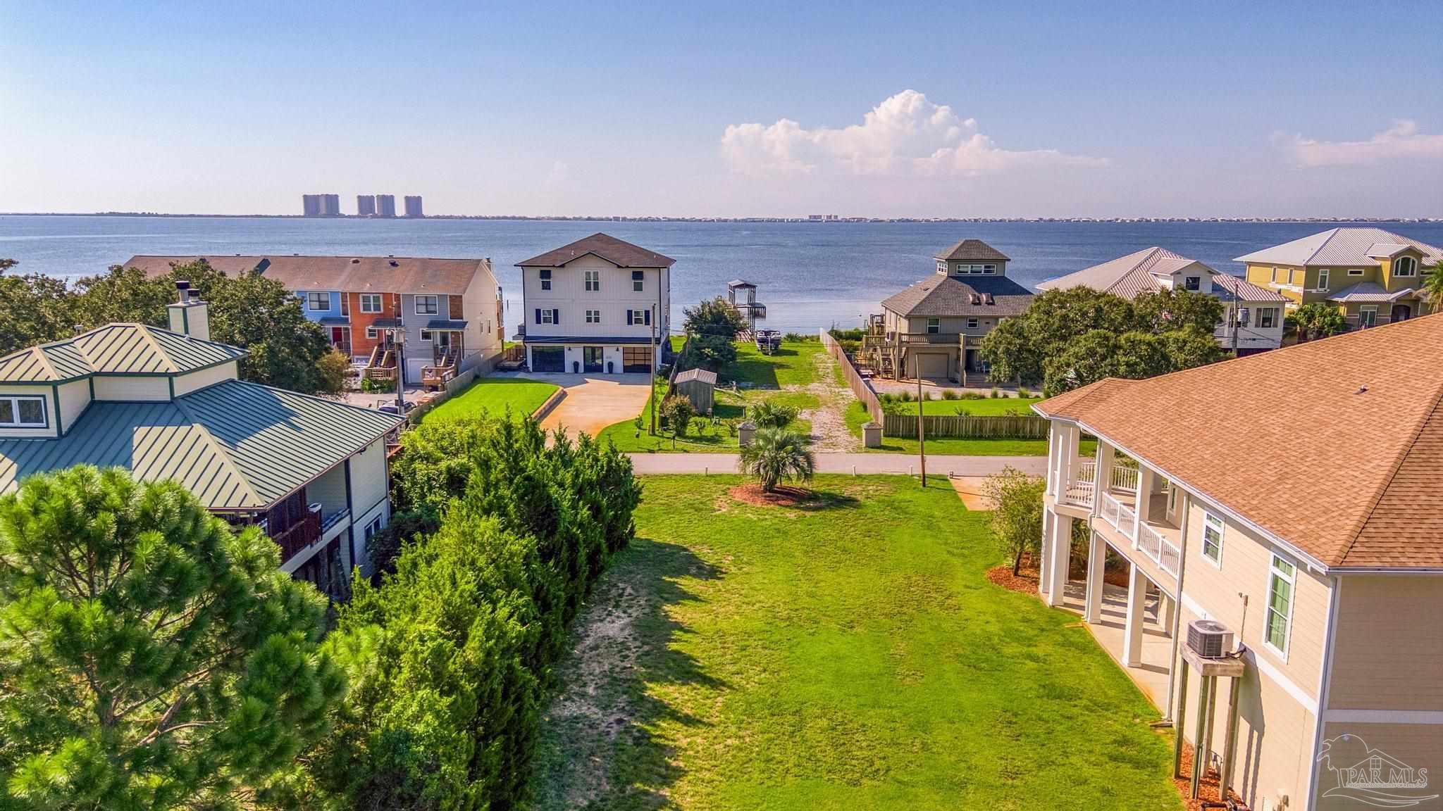 an aerial view of multiple houses with a yard