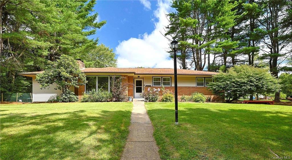 Ranch-style home with a front lawn