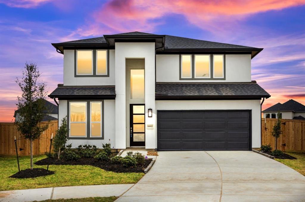 Step into modern elegance with this home's striking facade, designed to impress at first glance.