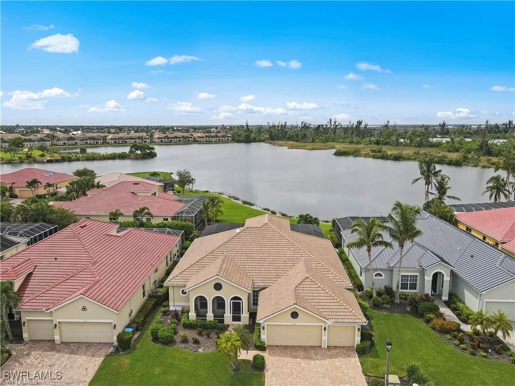 an aerial view of a house with outdoor space and lake view