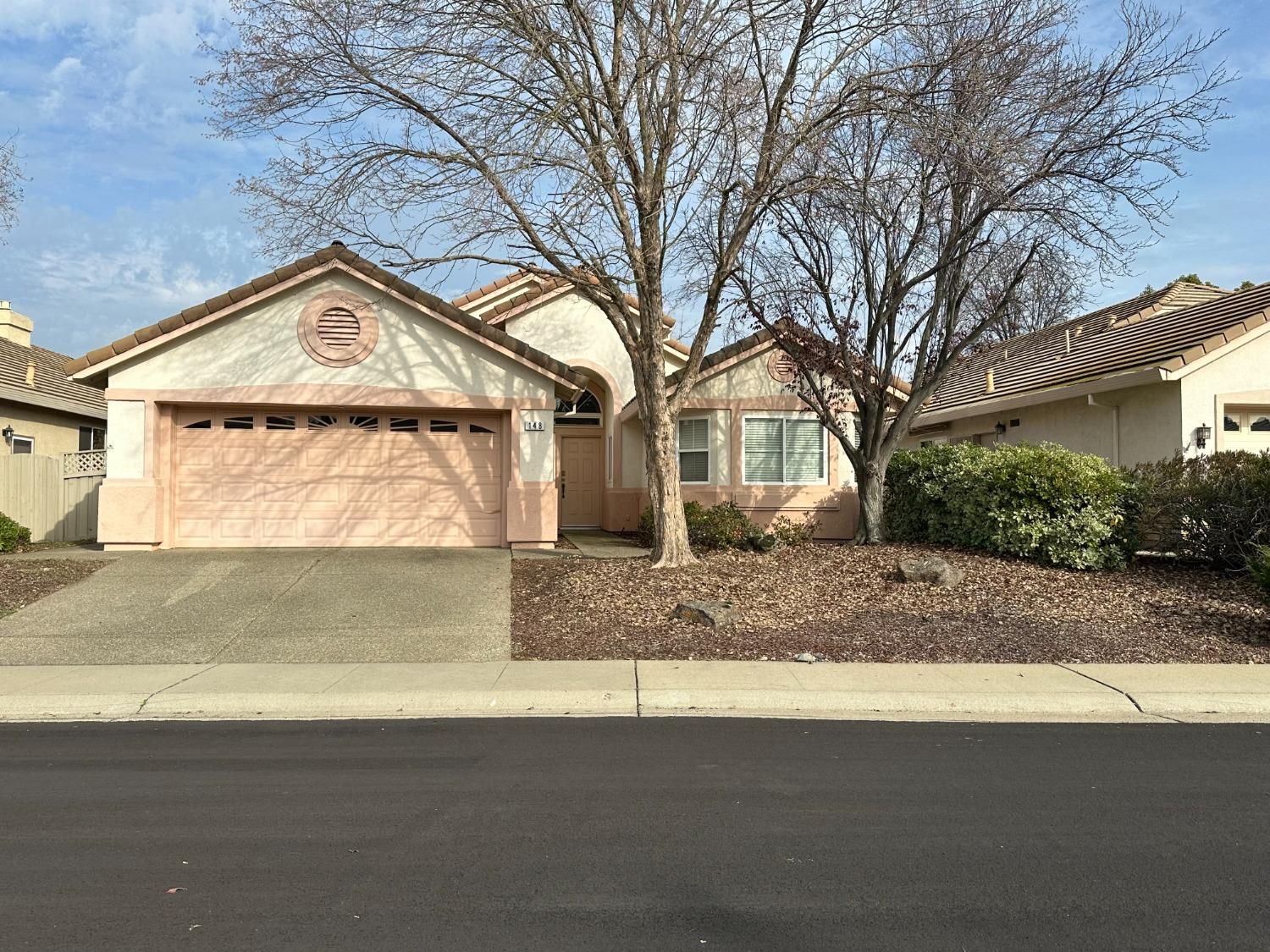 a view of a house with a yard and garage