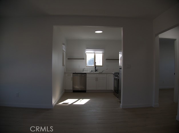 a view of a hallway with a kitchen