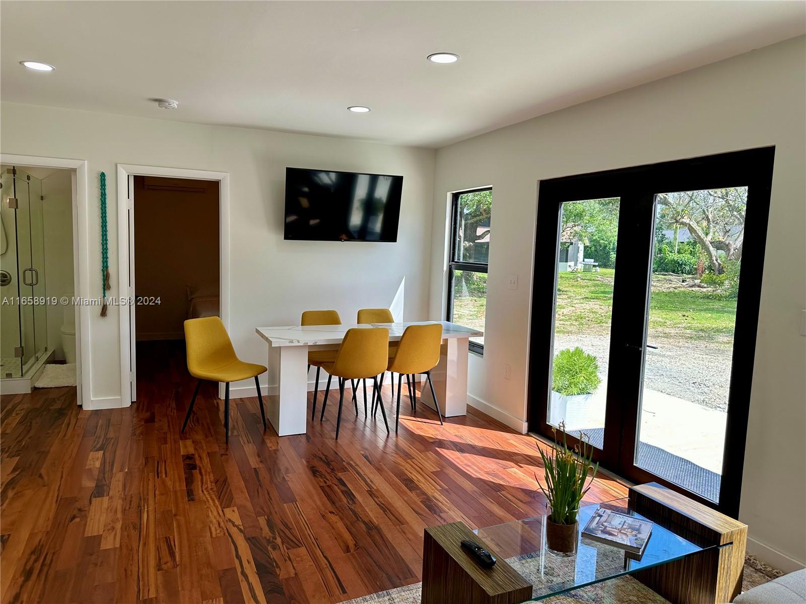 a view of a livingroom with furniture window and wooden floor