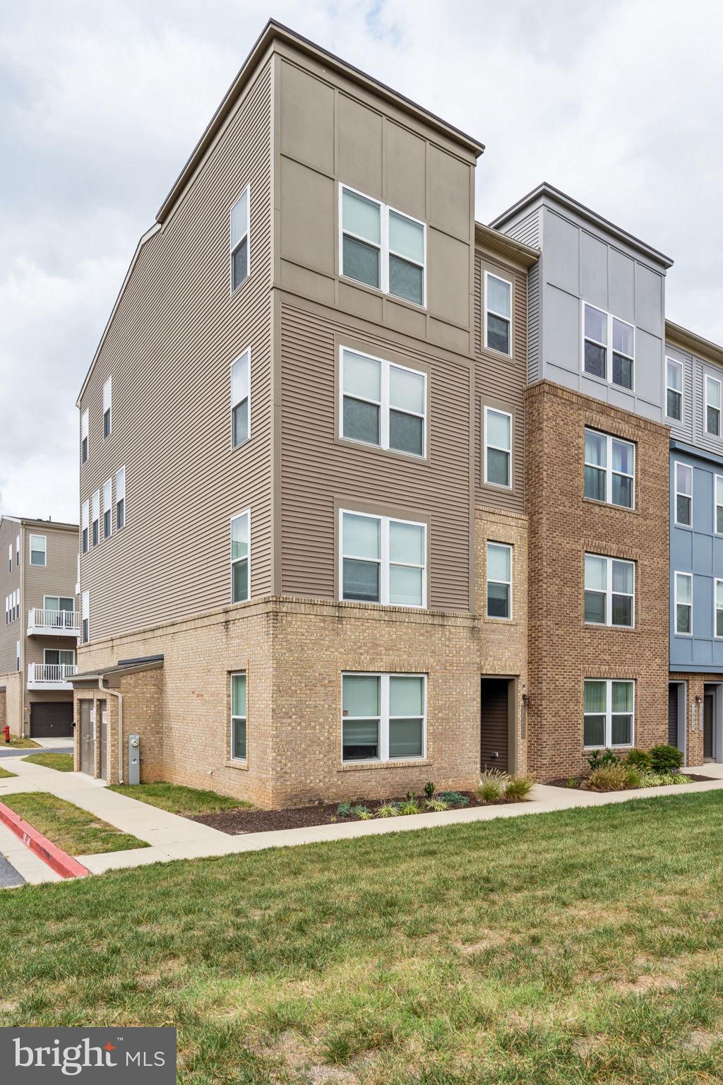 a tall white building with a yard