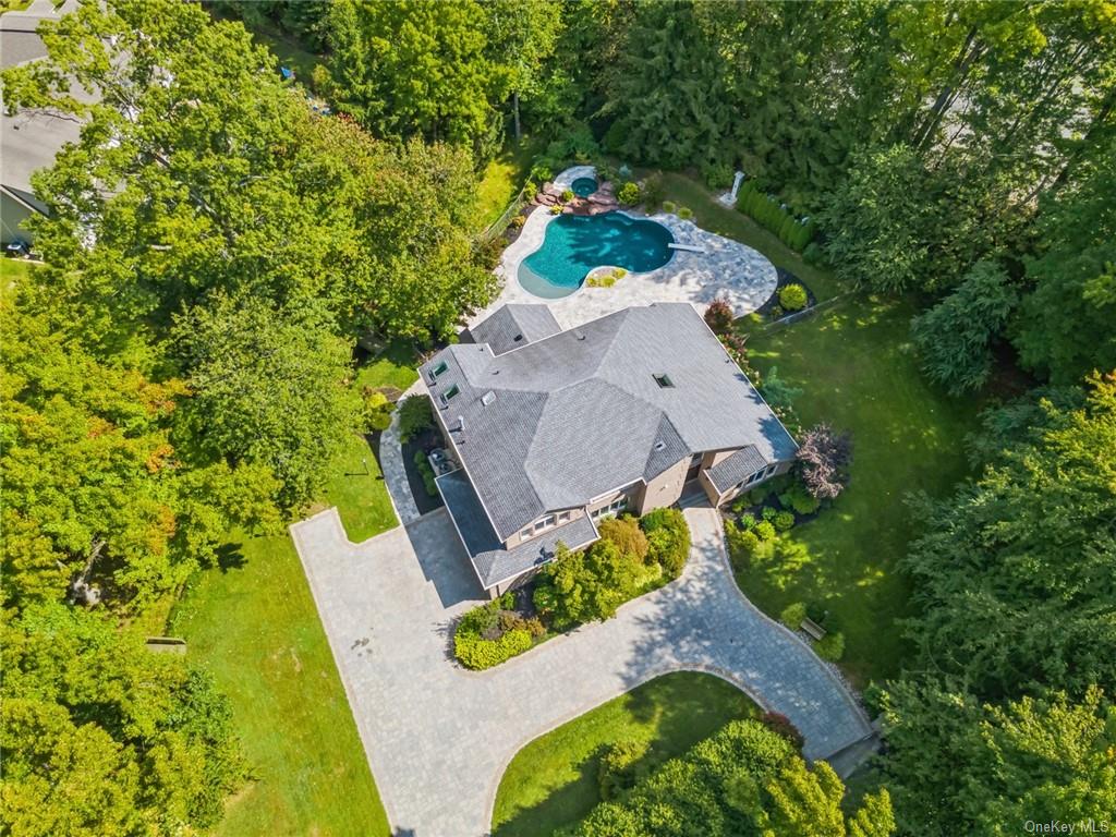 an aerial view of a house with a yard and trees