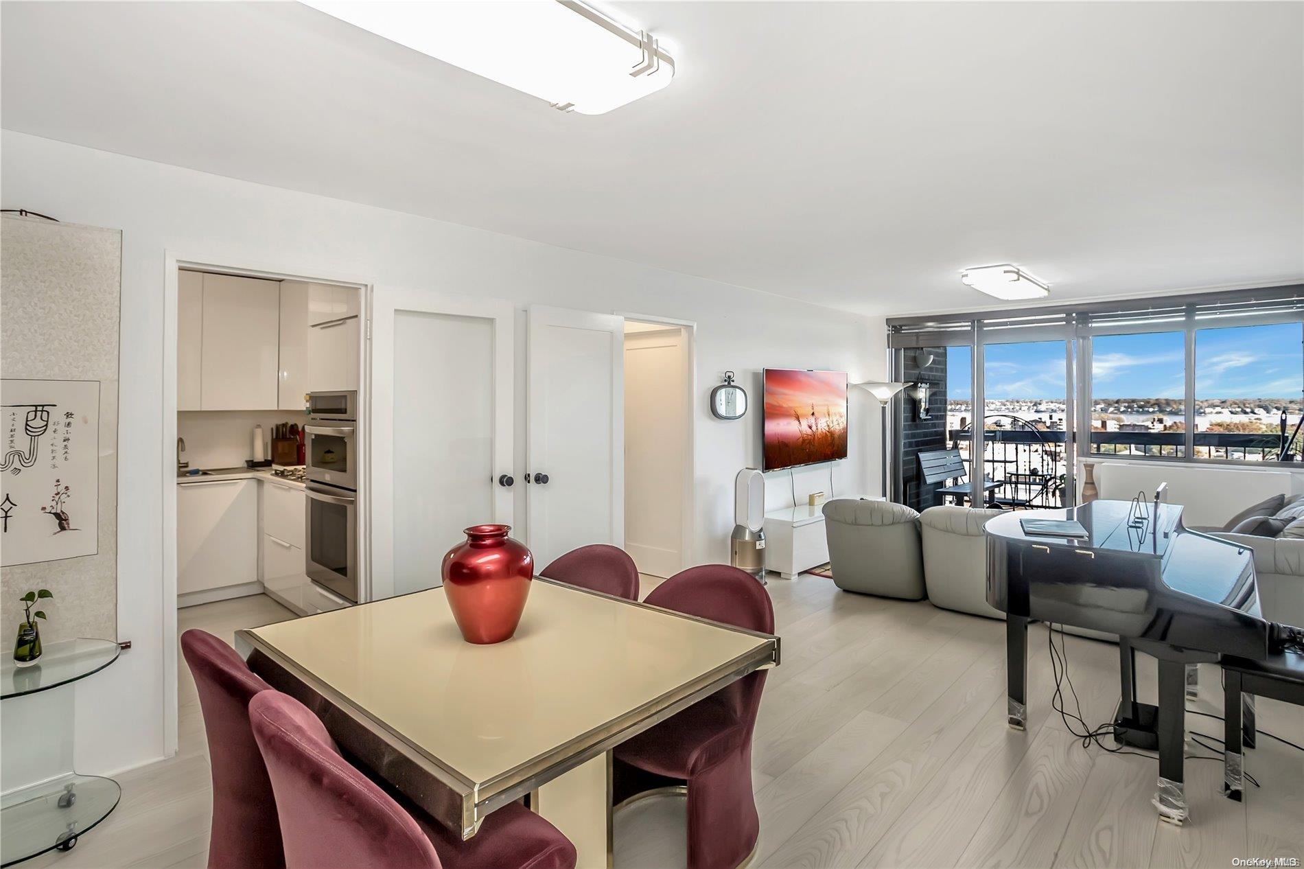 a kitchen with a dining table chairs and a refrigerator