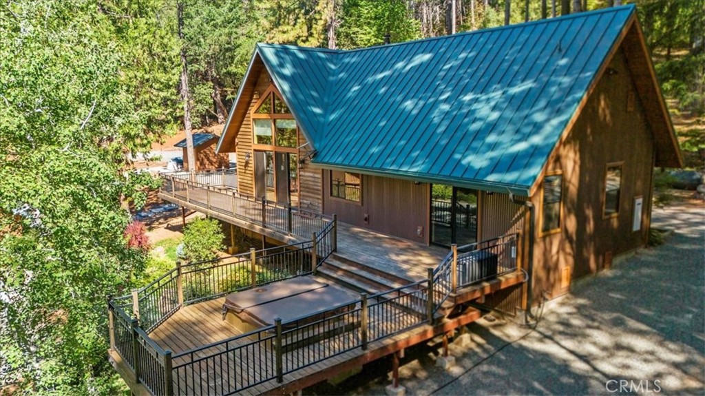 a view of backyard with deck and outdoor seating