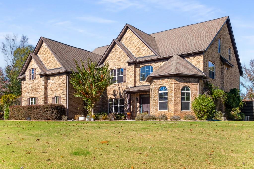 a front view of a house with garden