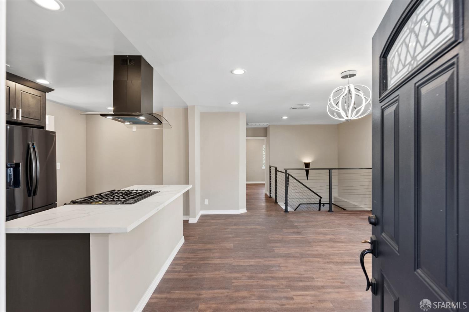 a kitchen with stainless steel appliances granite countertop a refrigerator and a sink