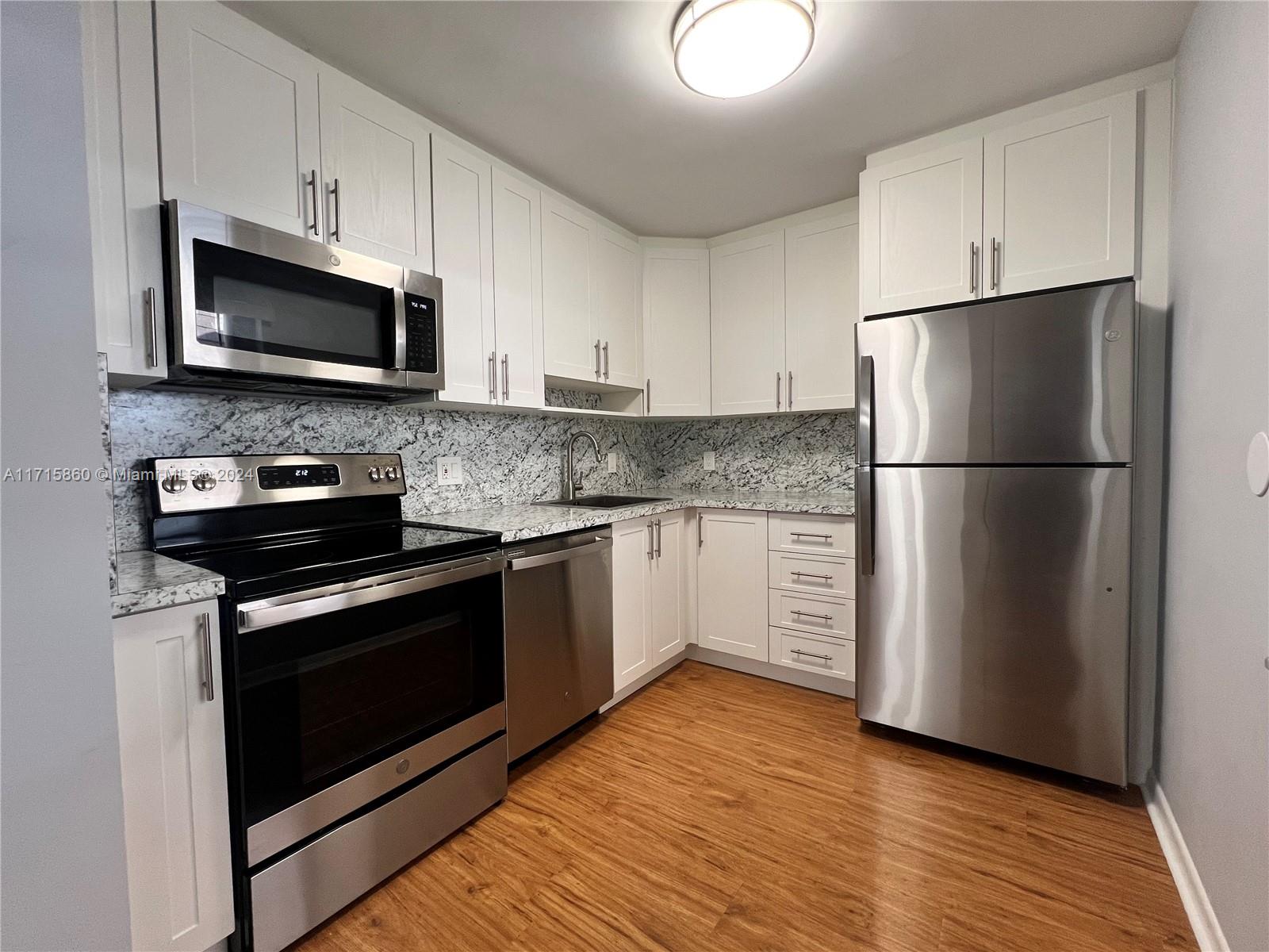 a kitchen with a refrigerator stove and microwave