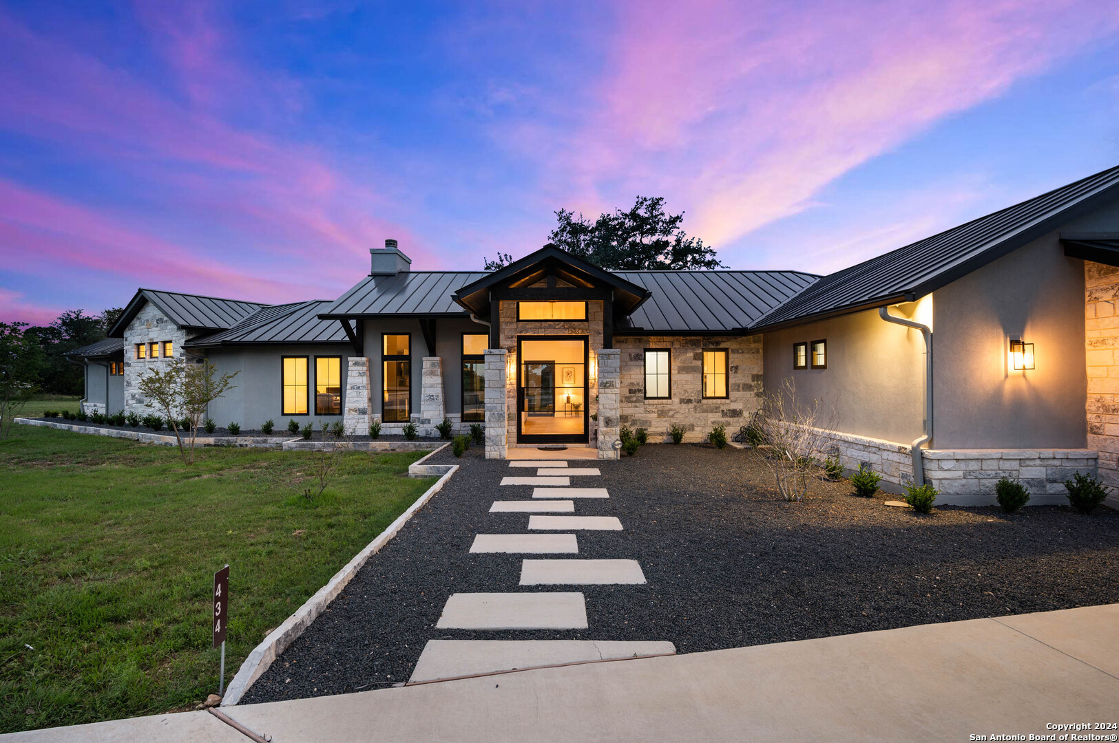 a front view of a house with a garden